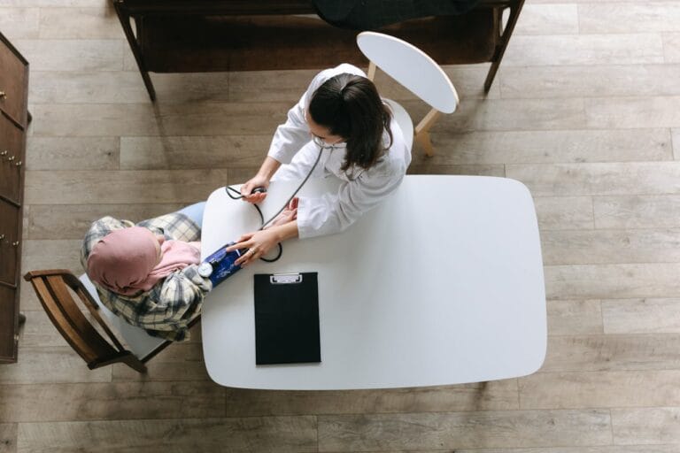 A doctor checking blood pressure of a patient