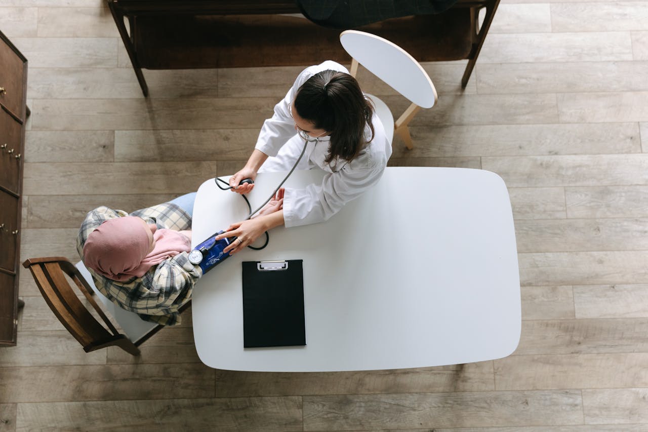 A doctor checking blood pressure of a patient